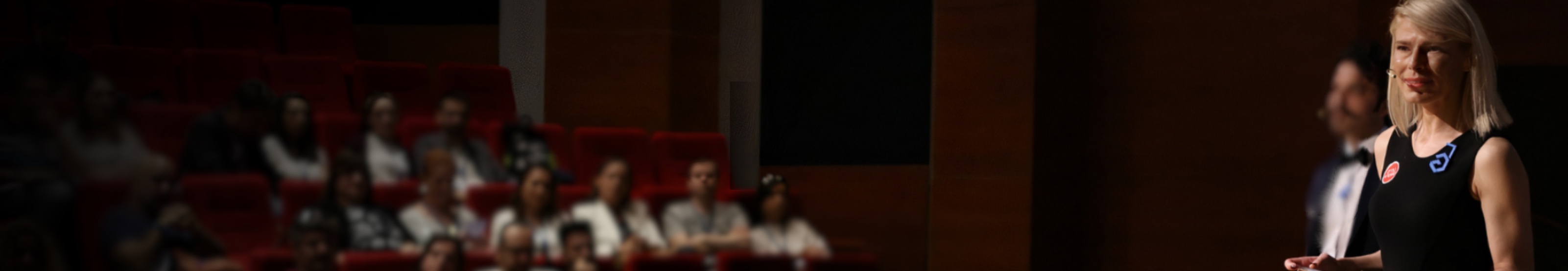 Funda Tabak speaking on stage to an audience